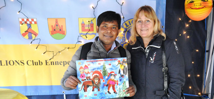 v.l. Shohag Rahman und Bettina Brökelschen mit dem Kinderadventskalender 2016 des Lions Club Audacia Foto:(c) Linde Arndt